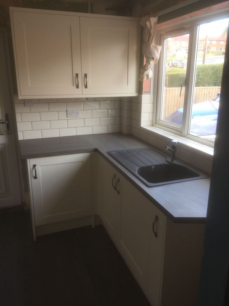 Classic Homebase Cream Kitchen with Ink Bark worktops, brick effect tiling & dark grey Lyvin Vinyl Flooring.: Swipe To View More Images