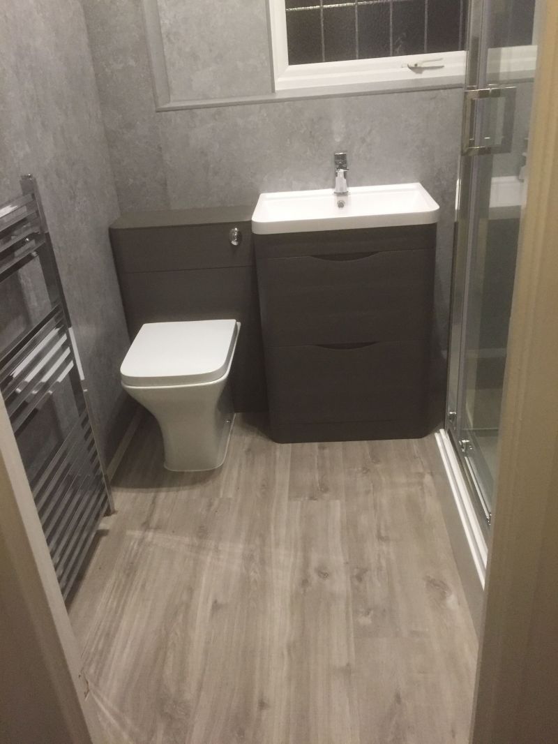 Rectangular shower enclosure fitted with electric shower.  Chrome Radiator, Grey Concrete Wall Boards on all walls and window ledge.  Light Grey Vinyl Click flooring.
: Swipe To View More Images