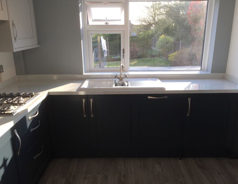 Homebase Navy Blue & Grey Shaker Style kitchen with White Sparkle Syllabub worktops and upstands.  Appliances were integrated.  Light Grey Vinyl flooring.: Swipe To View More Images