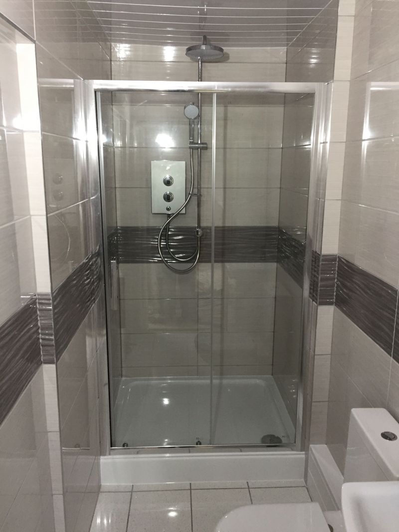 Customers converted the hallway into a shower room off the main bedroom whilst an extension to the property was done.

We have carried out all the wall and floor tiling and installed shower, toilet, vanity unit with sink and tall storage unit together with a UPVC white and chrome ceiling.: Swipe To View More Images