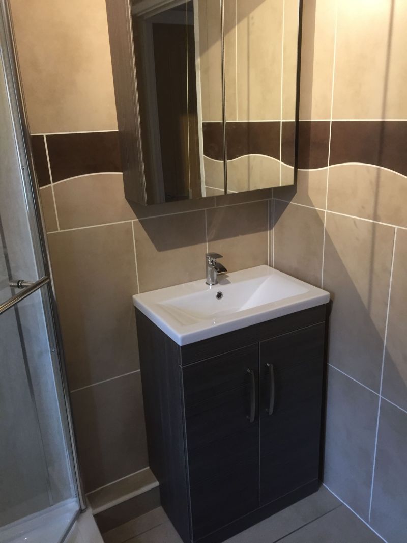 This bathroom was installed in 2012 and we have just recently returned to supply and fit a new vanity unit and wall cabinet in a very nice Brown Grey Avola.  : Swipe To View More Images