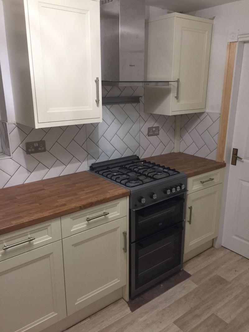 Homebase French Cream range, Golden Oak worktop with metro tiles in Herringbone design throughout kitchen and utility area.: Swipe To View More Images