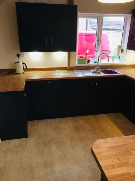 omebase Navy range, Golden Oak worktops and upstands. This kitchen.  Pewter Handles. 
The flooring in Quick Step Livyn Cream Travertine.  Integrated fridge freezer, washer dryer & dishwasher. Under unit lights.  Curved black splash back, gas hob on glass, electric oven and extractor.: Swipe To View More Images