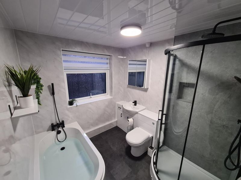 Complete design, supply and fit package.  Nuie vanity range, curved bath, off set quadrant shower and black fixtures.  Stunning bathroom.: Swipe To View More Images