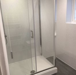 Shower Room with walk in chrome cubicle, Mira thermostatic shower, vanity unit & toilet set, white towel rail.  White sparkle UPVC Cladding, Dark Grey Livyn Click flooring.: Click Here To View Larger Image