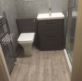 Rectangular shower enclosure fitted with electric shower.  Chrome Radiator, Grey Concrete Wall Boards on all walls and window ledge.  Light Grey Vinyl Click flooring.
: Click Here To View Larger Image