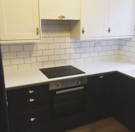 B&Q Dark Blue and Bright White Kitchen range, White Worktops, Grey Vinyl Flooring and White Brick effect tiling with Manhattan Grey grout.: Click Here To View Larger Image