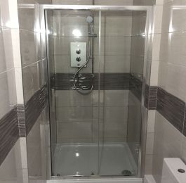 Customers converted the hallway into a shower room off the main bedroom whilst an extension to the property was done.

We have carried out all the wall and floor tiling and installed shower, toilet, vanity unit with sink and tall storage unit together with a UPVC white and chrome ceiling.: Click Here To View Larger Image