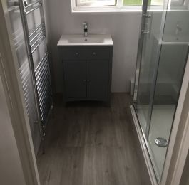White Sparkle on the main bathroom walls and a contrasting grey sparkle in the shower!

A new shower tray, glass door and side panel with chrome trim, electric shower, and toilet supplied and fitted together with customers own Vanity unit & basin. A Light Grey Vinyl Click flooring fitted in bathroom and separate toilet area. : Click Here To View Larger Image