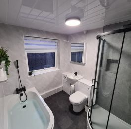 Complete design, supply and fit package.  Nuie vanity range, curved bath, off set quadrant shower and black fixtures.  Stunning bathroom.: Click Here To View Larger Image